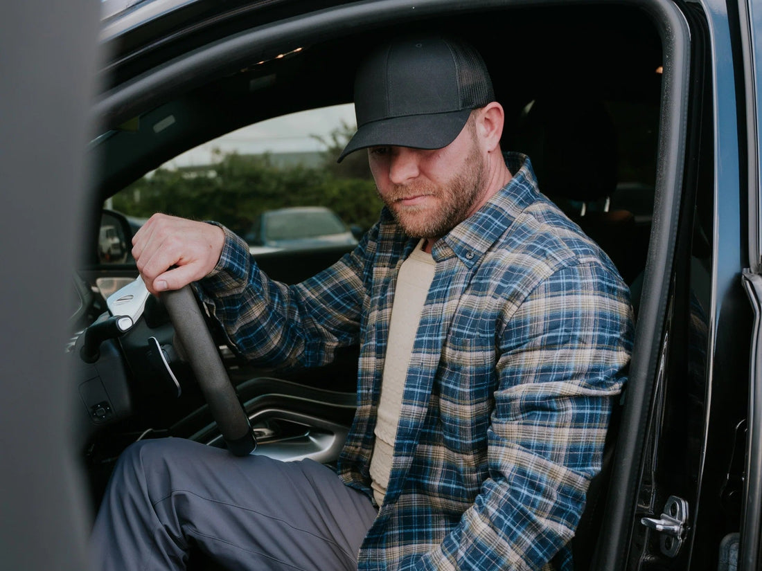 A mean wearing concealable soft body armor getting out of his car
