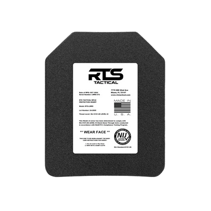 A tactical body armor plate with a white label on the front. The label includes product details, manufacturing standards, and origin