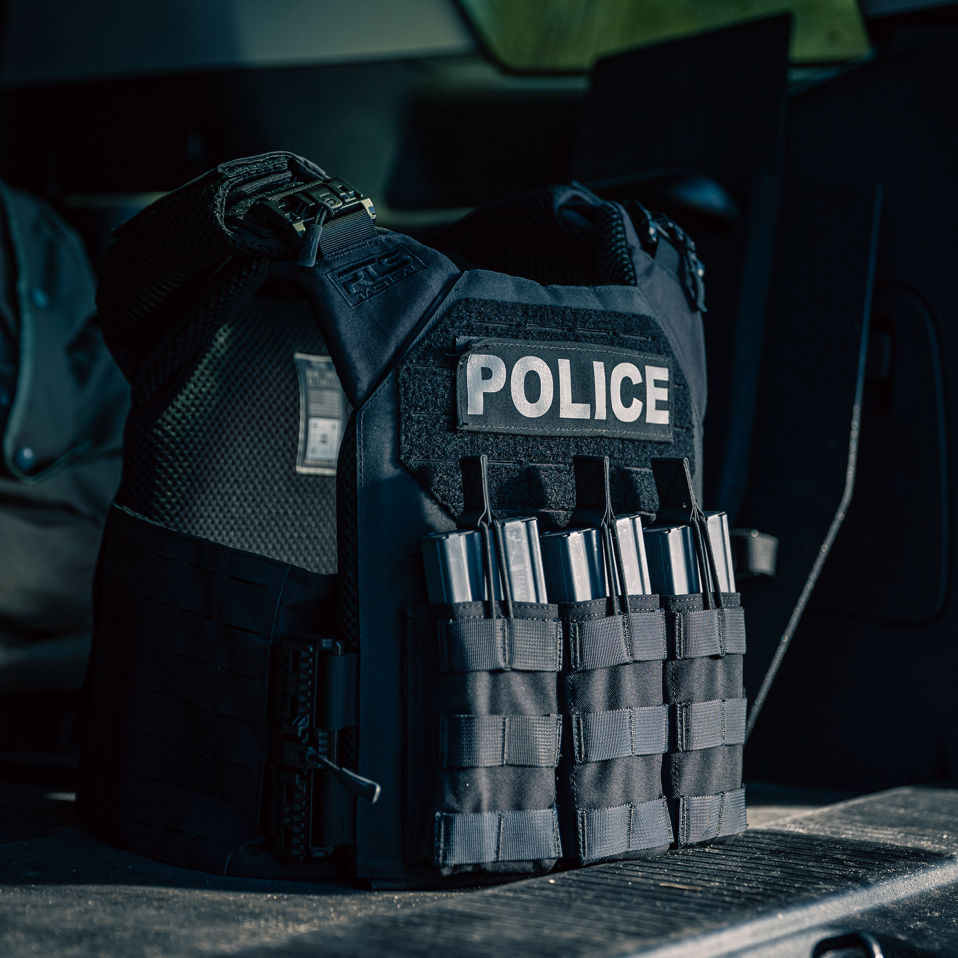 A police tactical vest with ammunition magazines is displayed in a vehicle.