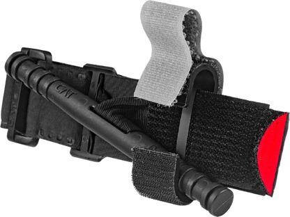 A black tactical tourniquet with a red tip and gray Velcro strap is shown.