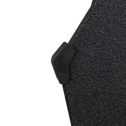 Close-up of a textured black armor plate with a small buffer bumper on the end with American flag.