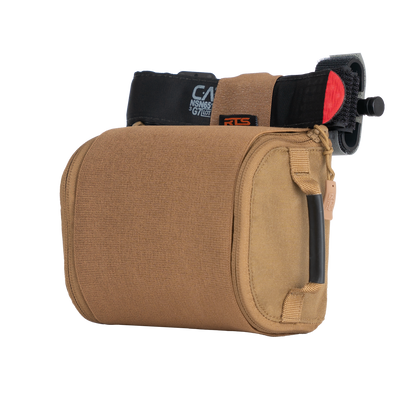 Portable IFAK pouch filled with medical equipment, including a tourniquet attached to the top.
