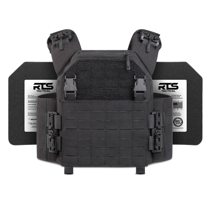 Black tactical vest with adjustable straps, buckle closures, and modular grid design. Two labeled ballistic plates visible in the background.