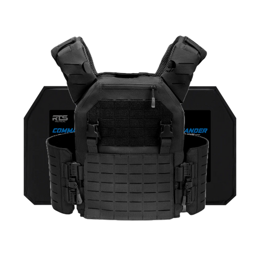 Black tactical vest with padded shoulder straps and multiple buckles is shown in front of two ballistic plates. The vest has a rugged, protective design.