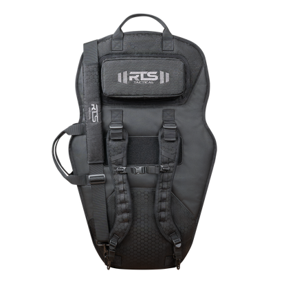 Tactical black ballistic shield carrier system with backpack straps and adjustable buckles. It features a top handle and a logo patch, conveying a rugged look.