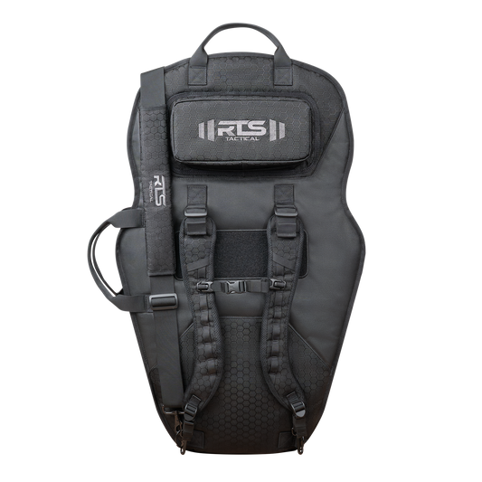 Tactical black ballistic shield carrier system with backpack straps and adjustable buckles. It features a top handle and a logo patch, conveying a rugged look.