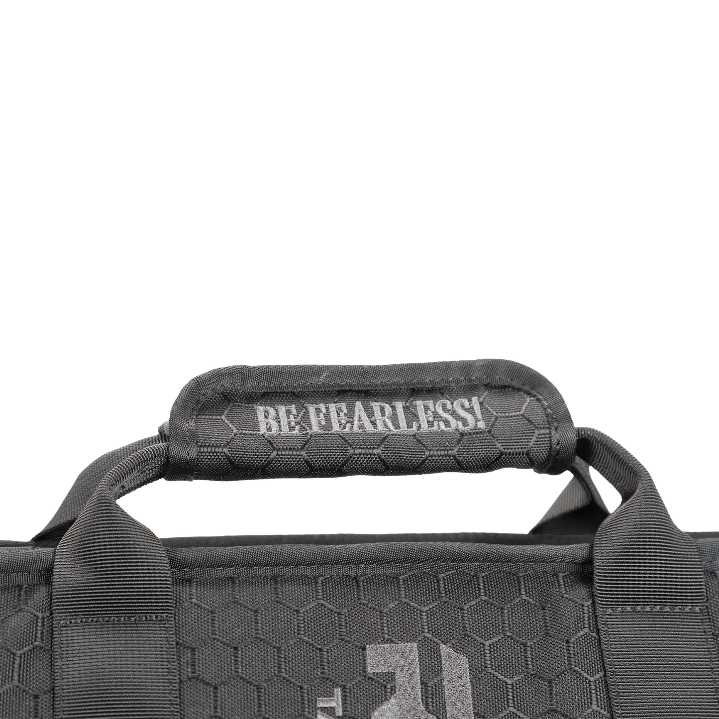 Close-up of a black shield carrier bag handle with a hexagonal texture, featuring the white text "BE FEARLESS!"