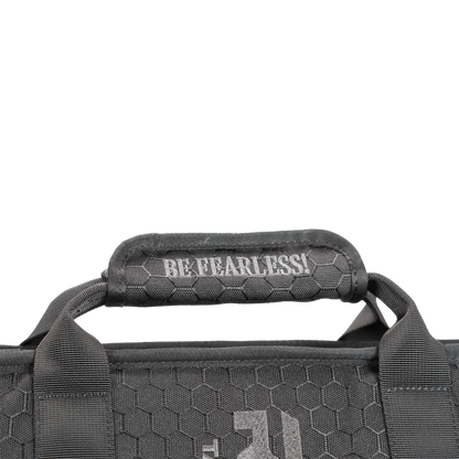 Close-up of a black shield carrier bag handle with a hexagonal texture, featuring the white text "BE FEARLESS!"