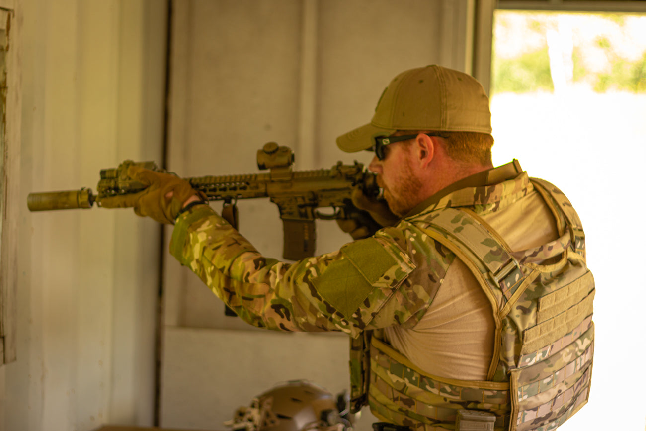 A man holding a gun wearing the Level IV Ceramic Active Shooter Kit from RTS Tactical.