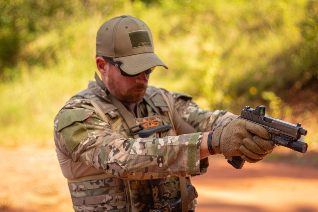 A man in military camouflage wearing an RTS plate carrier from the Level IV Ceramic kit.