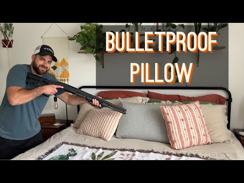 Man holding a shotgun poses beside a bed with pillows; text reads "Bulletproof Pillow".