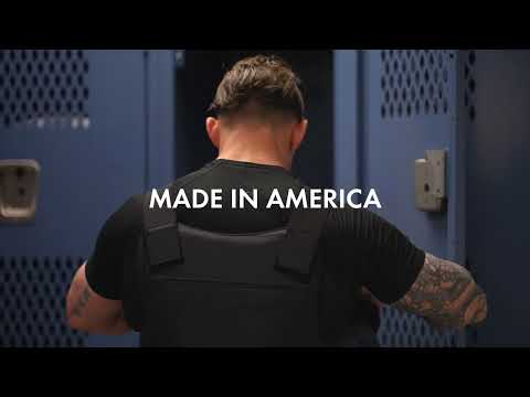 Man facing lockers, wearing tactical vest. Text reads "MADE IN AMERICA."