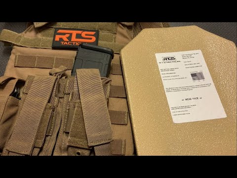 Tan tactical vest with pocket holding a magazine, featuring RTS logo. Next to it, a protective plate with specifications label, on a dark surface.
