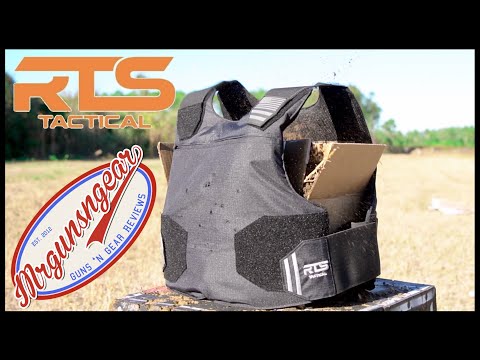 A black RTS Tactical bulletproof vest displayed outdoors, showing wear with a logo in the corner and an emphasis on protective gear.